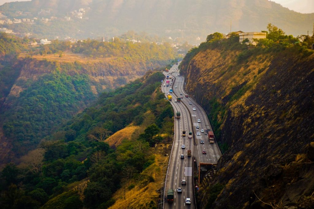 A scenic view of a busy highway winding through the lush hills of Lonavala, Maharashtra, India.